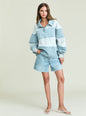 Model wearing Cher Denim Top in light blue color-block polo style with a collar, paired with denim shorts thumbnail image 3 of 6