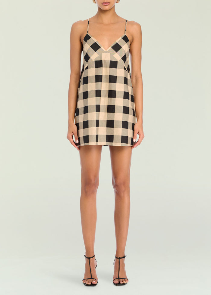 Front view of a beige and black gingham linen mini dress with thin straps.