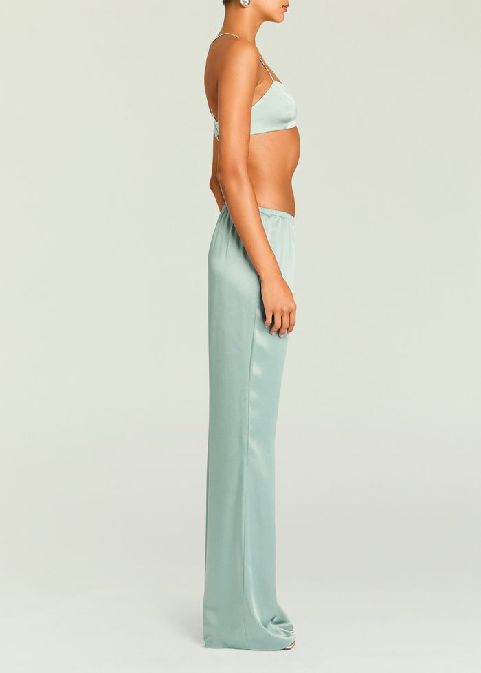 Side view of pastel green satin Courtney Bralette with crossed back straps and elastic band, paired with matching satin pants.