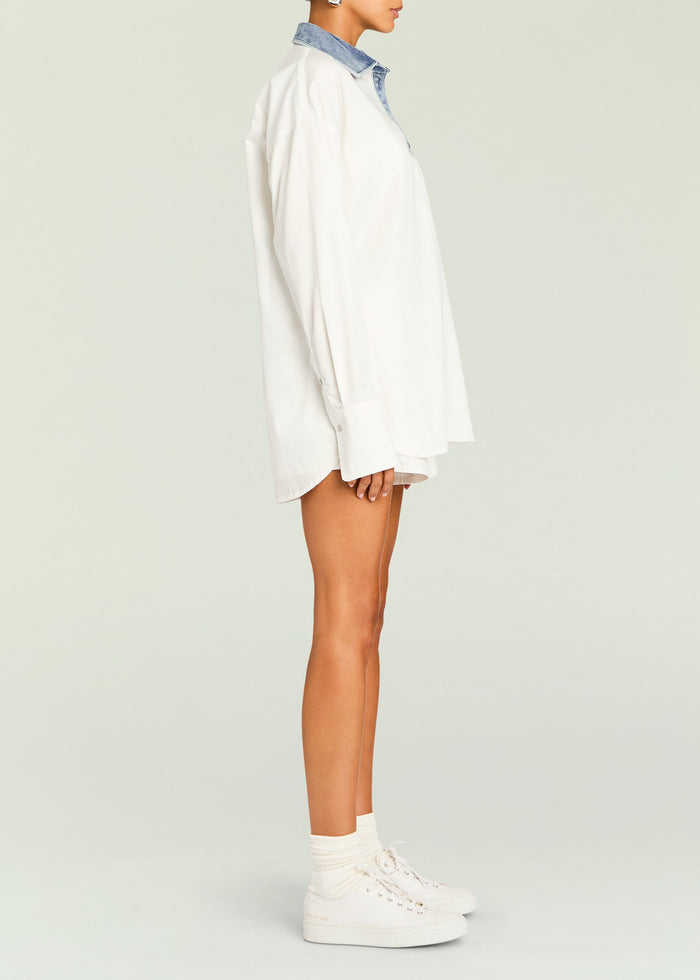 Side view of white Gill Oversized Shirt with denim collar paired with white shorts and sneakers
