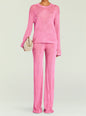 Front view of a model in a pink metallic knit sweater and pants with a beige woven bag thumbnail image 2 of 5