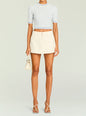 Front view of a model in a beige A-line mini skirt paired with a pale blue knit crop top thumbnail image 2 of 5