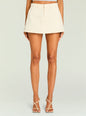 Cream A-line mini skirt with belt loops worn with a light blue cropped knit top. thumbnail image 1 of 5