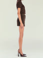Side profile of a model wearing a brown suede cropped top with a matching mini skirt. thumbnail image 3 of 5
