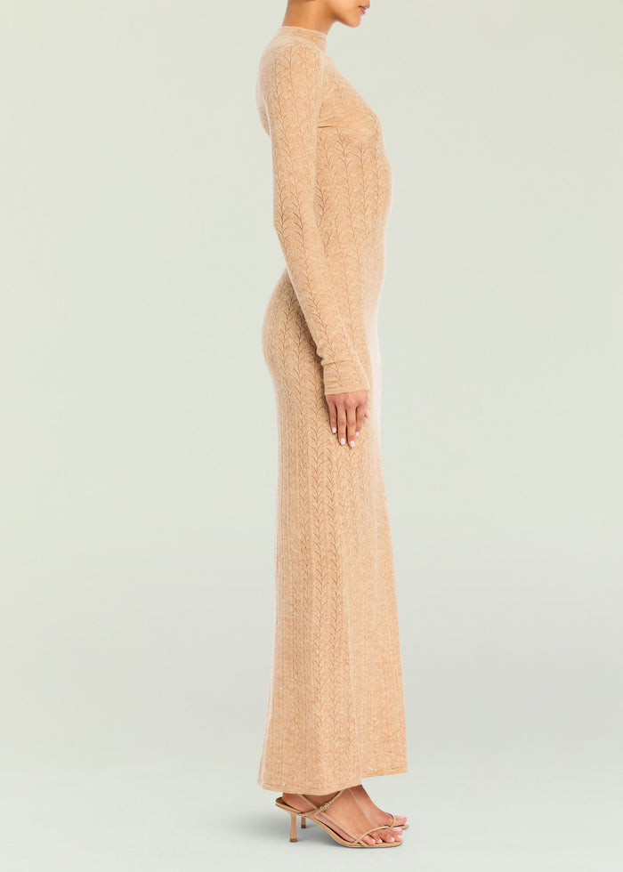 Side view of a peach knit maxi dress on a model with long sleeves and a fitted silhouette.