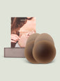 NOOD shape tape breast tape packaging with a model in brown attire and stacked beige rolls thumbnail image 1 of 2