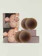 NOOD no show nipple covers packaging with nude silicone cups arranged beside the box. thumbnail image 1 of 2