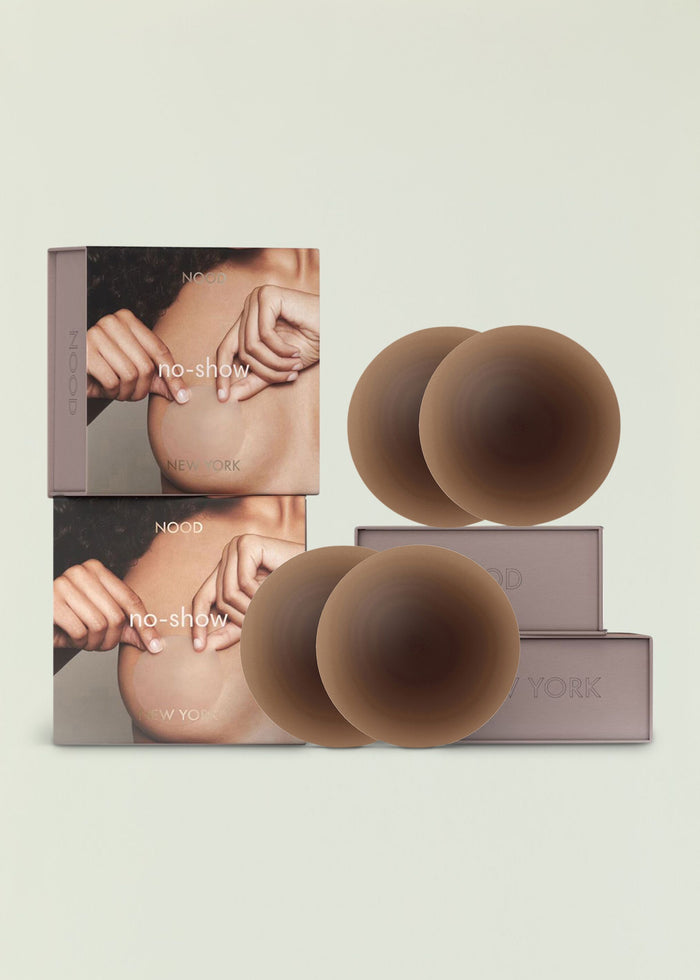 NOOD no show nipple covers packaging with nude silicone cups arranged beside the box.
