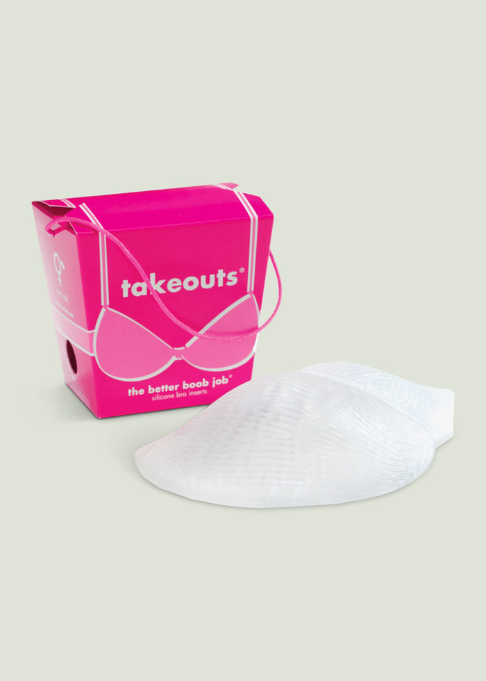 Pink Commando Takeouts packaging box with silicone bra inserts beside it